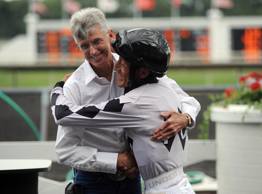 Jockey Francisco Torres and trainer Danny Miller share a hug after a win at Arlington Park. (Eclipse Sportswire)