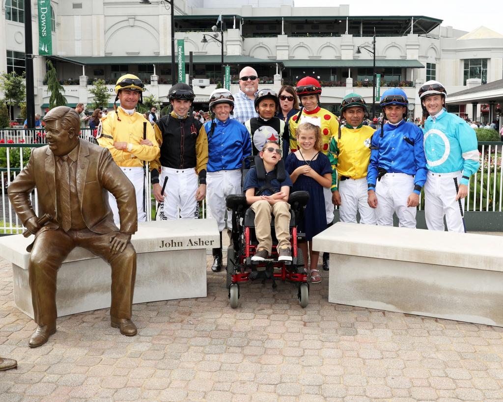 The Dormans with Churchill Downs jockeys. (Coady Photography)