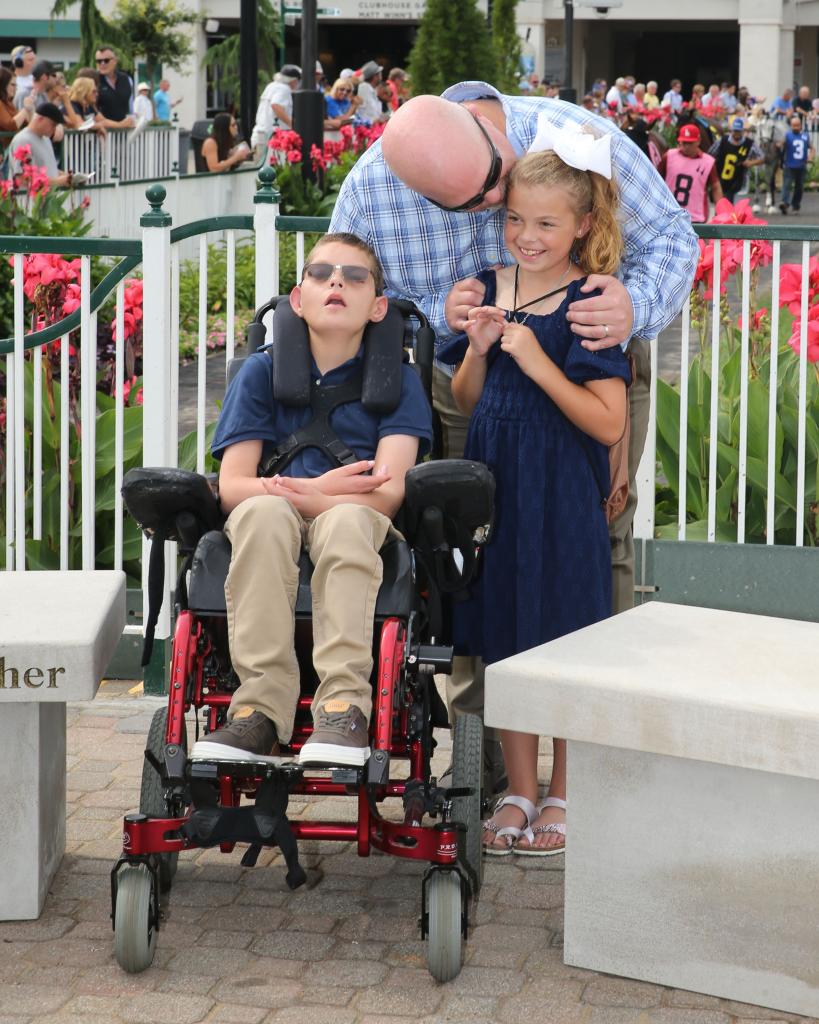 Father Kelly with Cody and Kylie. (Coady Photography)