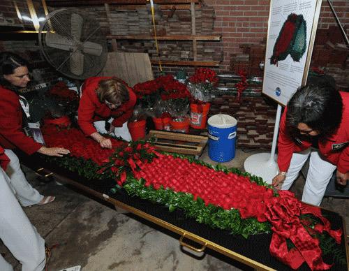 Kroger employees hard at work on the rose garland. (Eclipse Sportswire) Kroger employees hard at work on the rose garland.