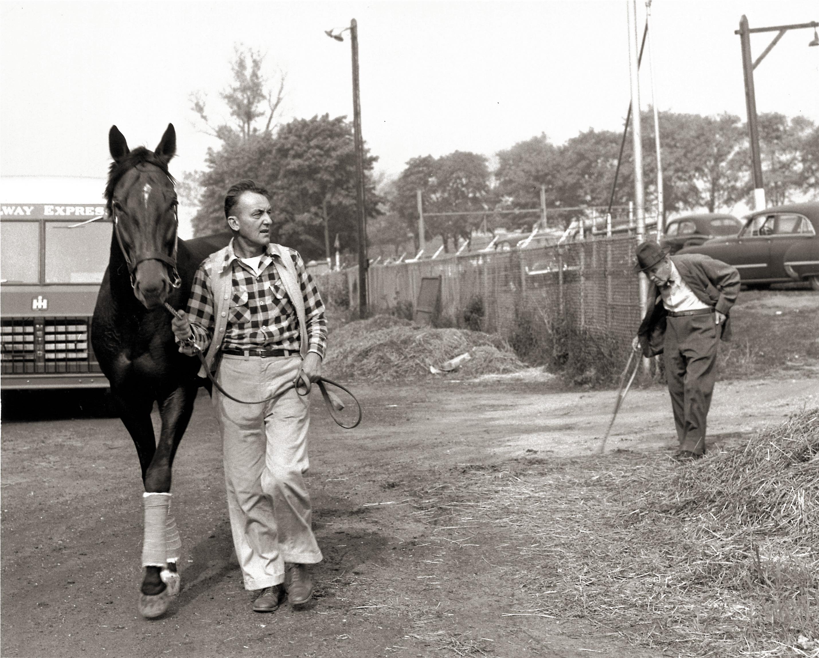 Nashua with his groom Alfred Robertson as Fitzsimmons looks on.