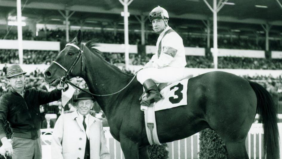 Johnny Longden, pictured in the winner's circle aboard Drill Site, is the only person to both train and ride a Kentucky Derby winner.