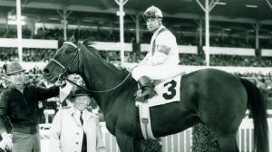 Johnny Longden, pictured in the winner's circle aboard Drill Site, is the only person to both train and ride a Kentucky Derby winner.